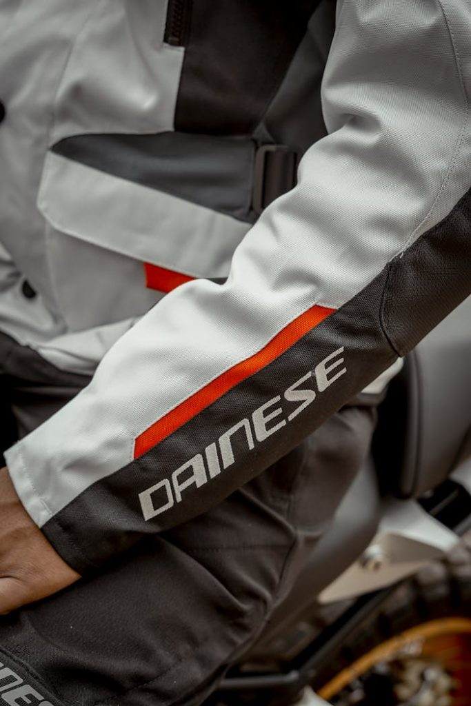 Close-up of a motorcyclists jacket sleeve featuring Dainese branding in Indio, CA.