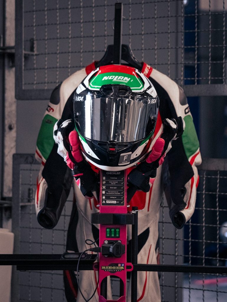 racers-helmet-and-suit-hang-neatly-on-a-stand-oyrzi-rlcuo